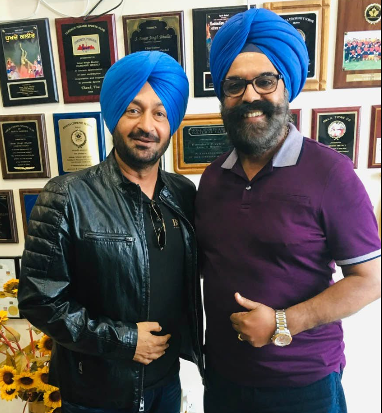 Piara Singh Kudowal with a fellow artist at a community office