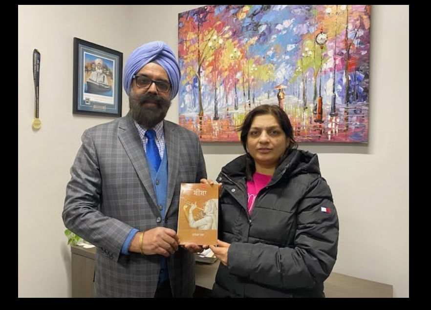 Piara Singh Kudowal sharing a poetry book with a reader